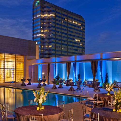 Multi-story Westin Galleria Hotel with pool and lounge area.